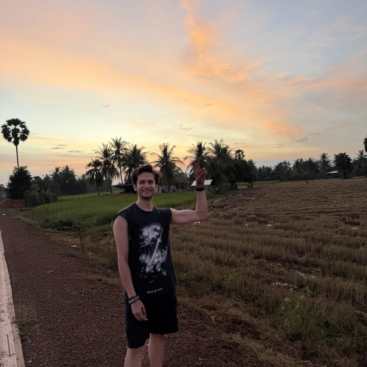 Monil waving at sunset among the palms of Kampot, Cambodia