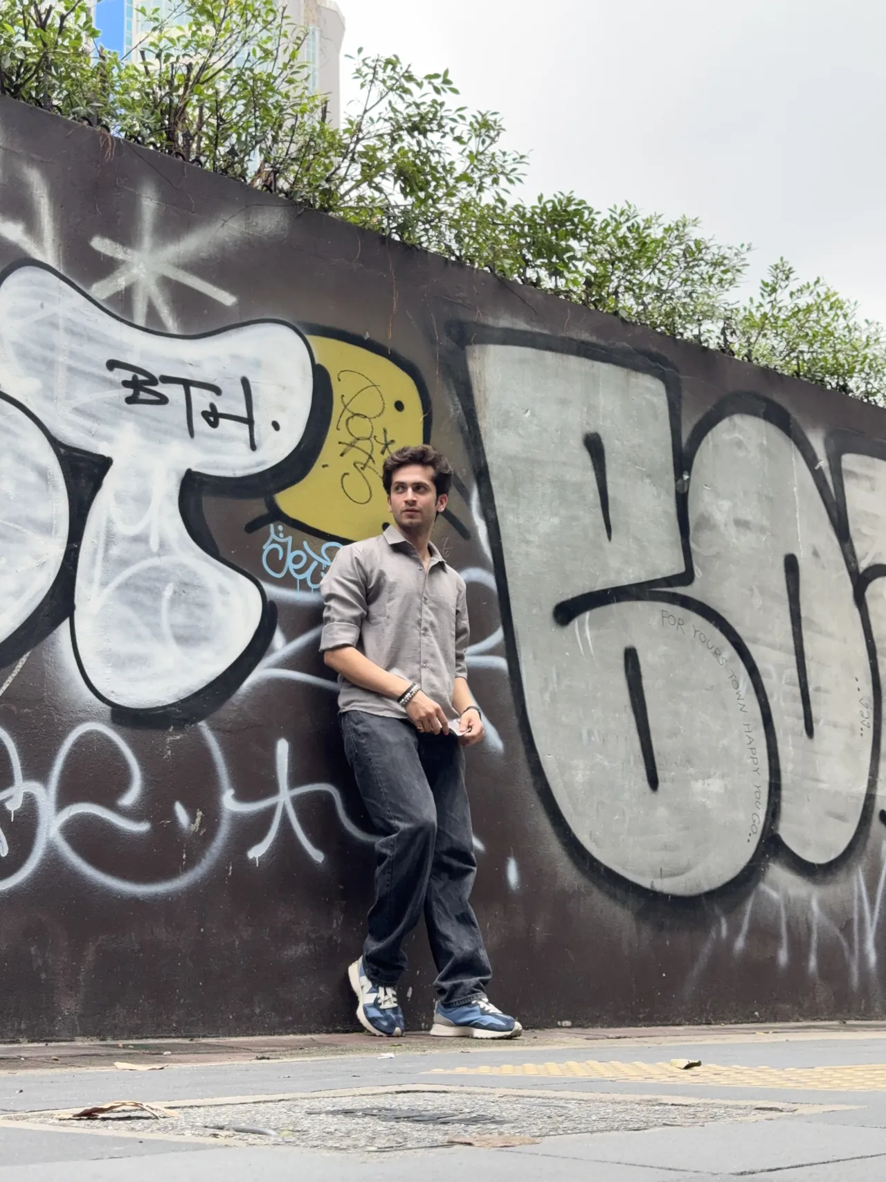Monil against a graffiti wall in Bangkok
