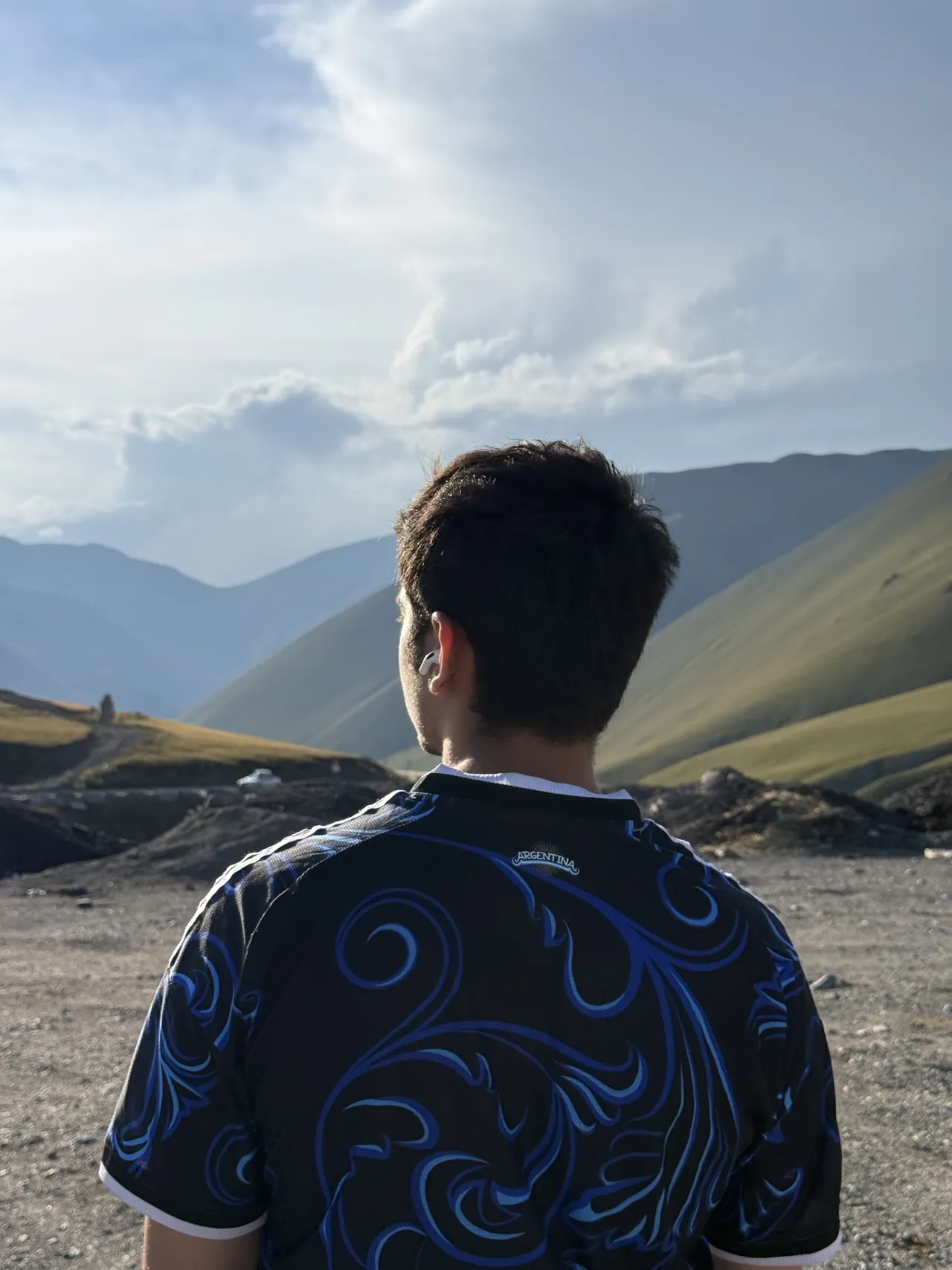 Monil looking out over a mountain valley in Kyrgyzstan