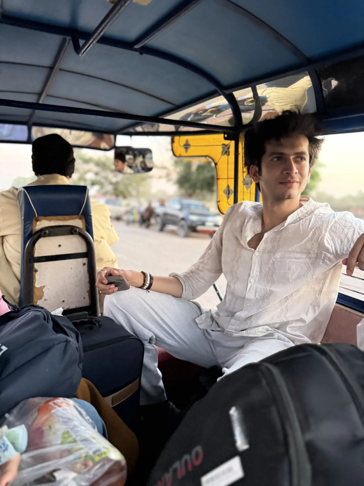 Monil riding a tuk-tuk with his bags in Vientiane, Laos